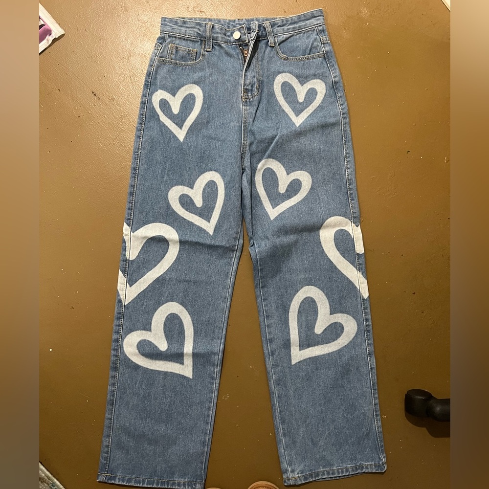 Never worn jeans with hearts on them, size medium